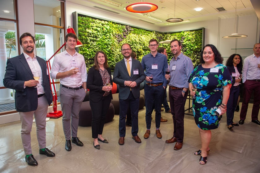 Hiscox team infront of living wall