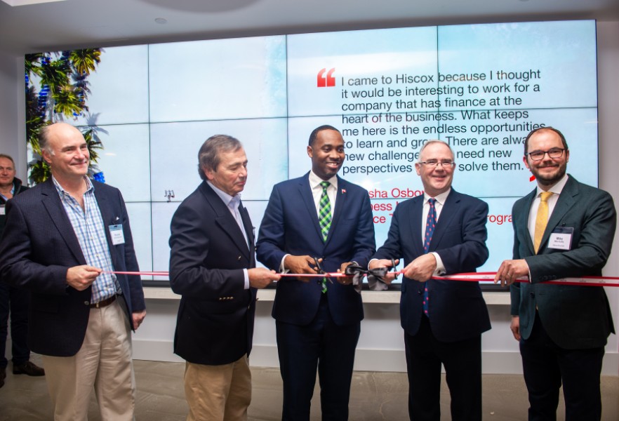 Leadership team cutting ribbon to Bermuda office